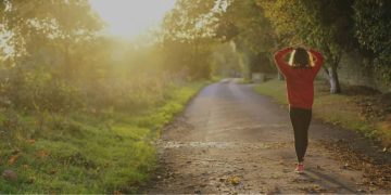 woman walking down a sunny path